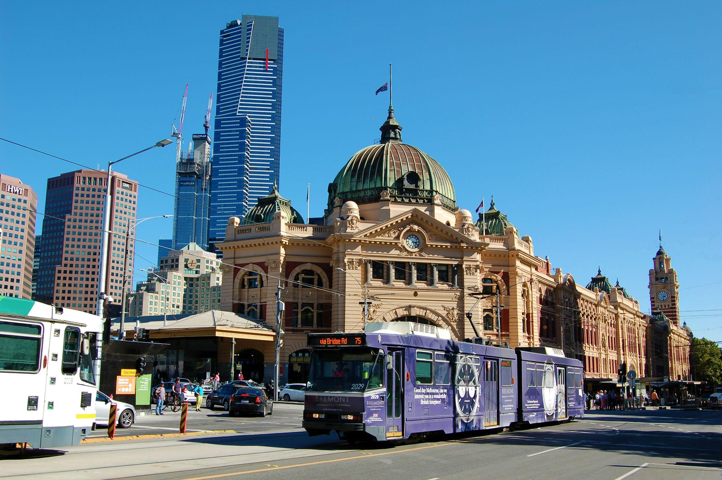 Flinders Street Station in Melbourne with a tram passing